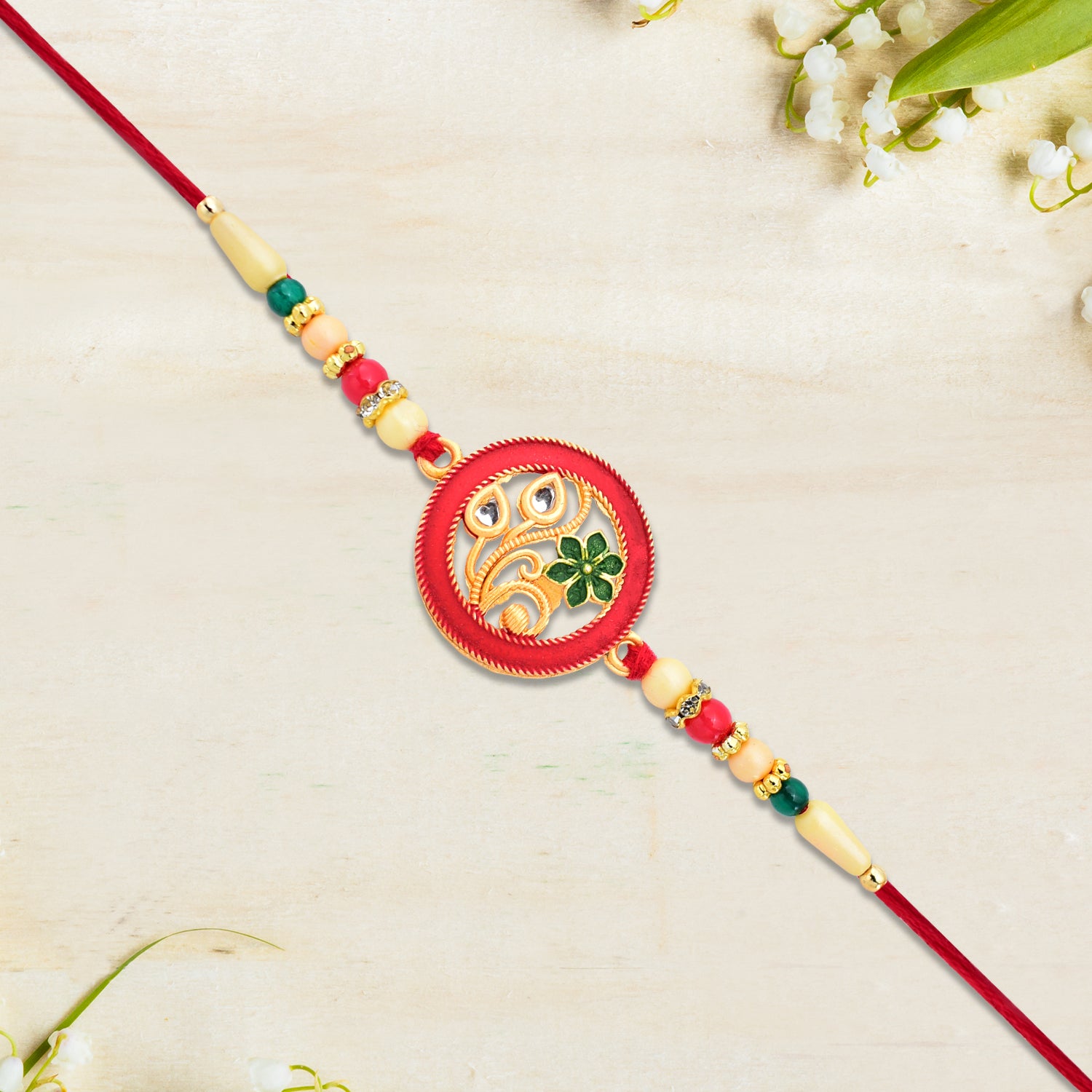 Round Designer Paisley Rakhi With Floral Charm Round Designer Paisley Rakhi With Floral Charm